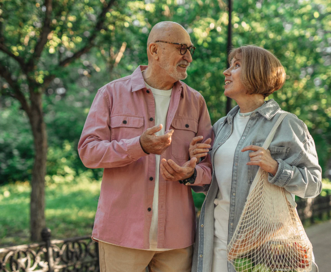 Retired couple walking through a park