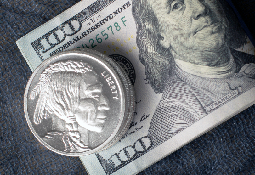 Image of a $100 bill and silver coins