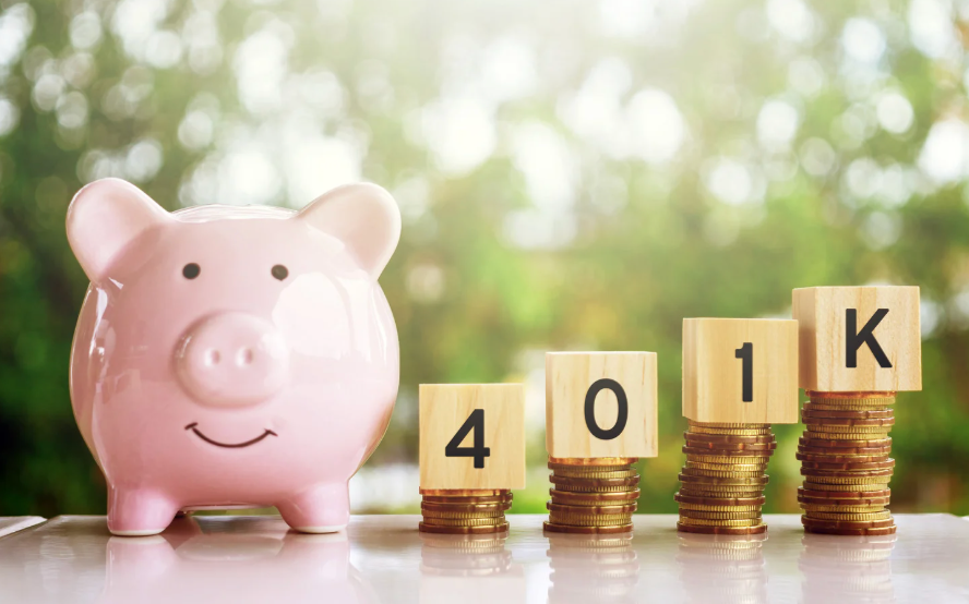 Piggy bank sitting on a desk with blocks that have the numbers 401 and a block with a K