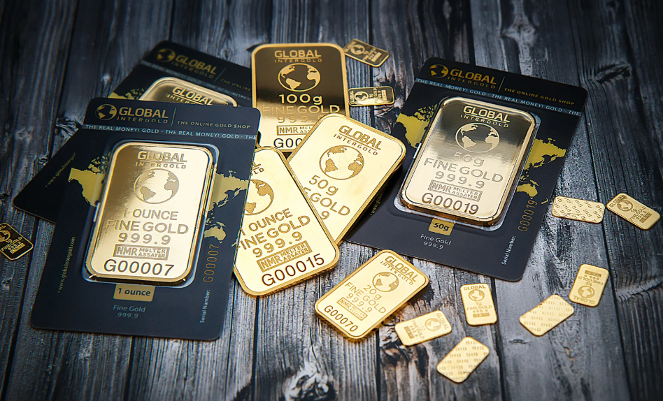 Several gold bars, which are numbered, laying on a table